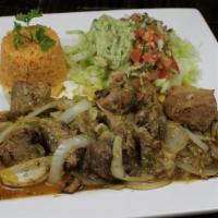 Carnitas Mexicanas · Chunks of pork cooked with onions and tomatillo sauce. Served with rice and a guacamole salad