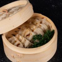 Pork Gyozas · Available steamed or deep-fried. Dumpling made with a delicate wrapper and filled with a mix...