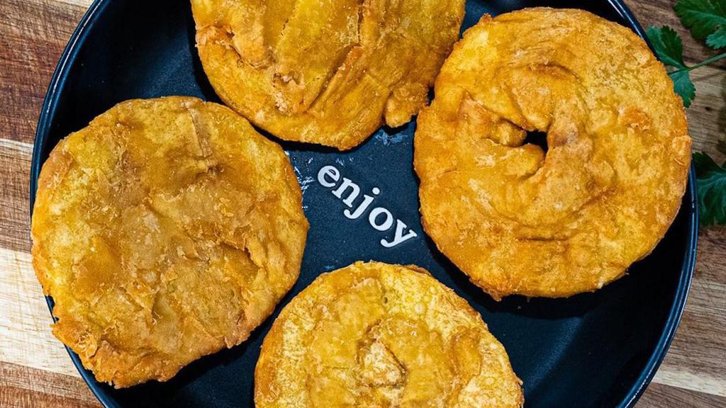Patacones · Fried green plantains.