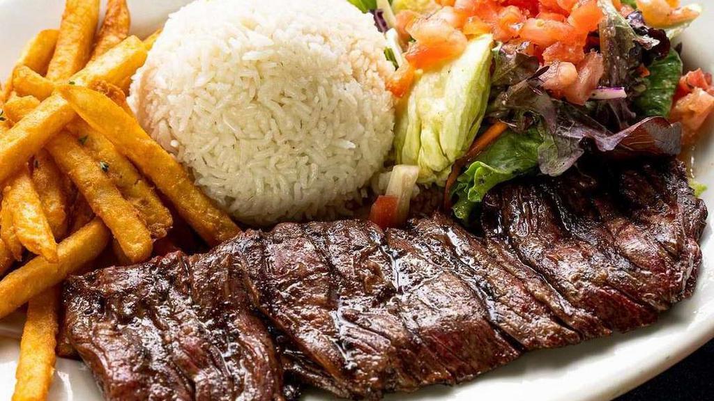 Carne Asada · A delicious wood grilled sirloin steak (10oz) marinated with spices. Served with white rice, French fries, and salad.