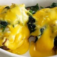 Florentine Benedict · Two poached eggs, spinach, and mushrooms served on a toasted English muffin with authentic h...