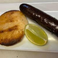 Morcilla Con Arepa · Blood sausage and white corn bread.