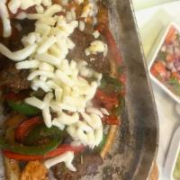 Fajitas Mexicanas · Grilled steak or chicken with tomatoes, onions and bell peppers served with lettuce, guacamo...