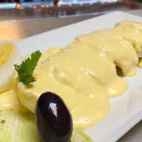 Papa A La Huancaina · Boiled potatoes topped with  a Yellow aji cheese sauce garnished with a hard boiled egg and ...