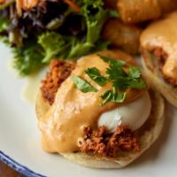 Lolo’S Eggs Benedict · Poached eggs* on English muffins, chorizo, and spicy mushroom cream sauce served with tater ...