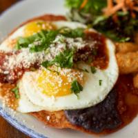 Huevos Rancheros · Sunny side up eggs* over tortillas, salsa,
crema, and cheese, served with tater and greens.