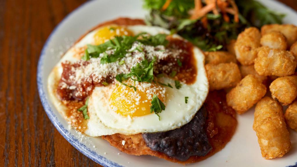 Huevos Rancheros · Sunny side up eggs* over tortillas, salsa,
crema, and cheese, served with tater and greens.
