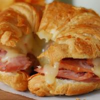 The Piggy Sandwich · A buttery croissant with sliced ham, fried egg and cheese.