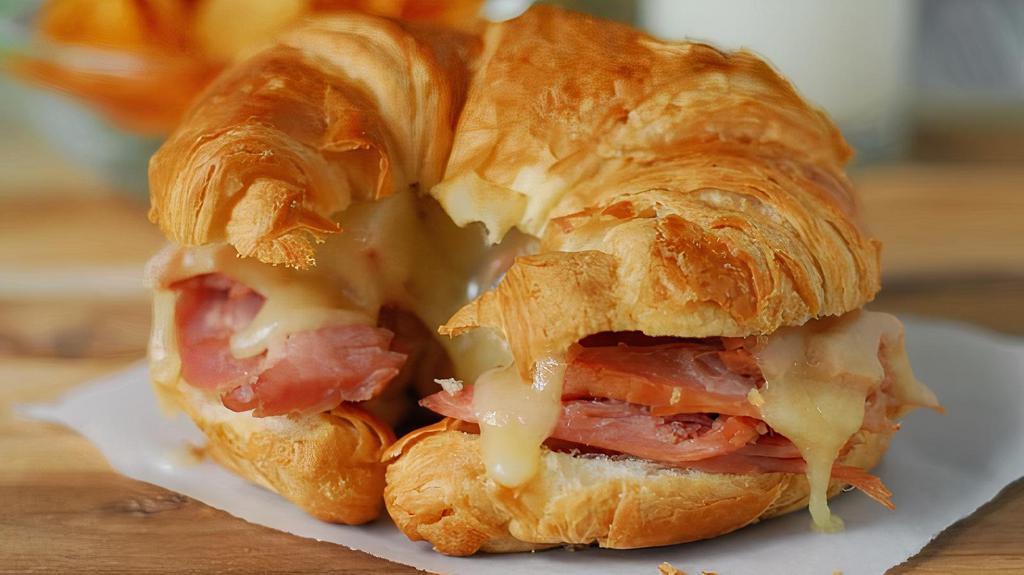 The Piggy Breakfast Sandwich · A buttery croissant with sliced ham, fried egg and cheese.