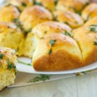 Garlic Rolls · Fresh and fluffy house made bread rolls topped with crushes garlic.