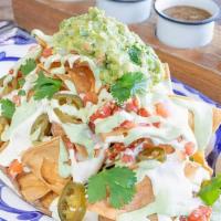 Nachos · Large platter of crispy tortilla chips with . Chihuahua cheese sauce, pickled jalapeno, . pi...
