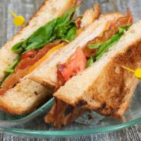 Turkey Club Sandwich · Turkey, bacon, melted cheddar cheese, lettuce, tomato and mayo on white bread.