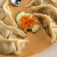 Pot Stickers With Red Curry · Delicate vegetable and pork filled dumplings. Served in a thai red curry sauce.