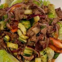 Spicy Beef Salad · Grilled marinated lean beef, tomatoes, onion, and cucumber in spicy surins sauce with romain...