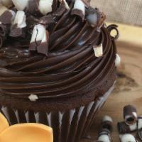 Triple Chocolate Cupcake · A luxurious chocolate cupcake with  heavenly chocolate fudge,
garnished with white chocolate...
