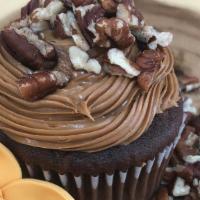 Millionaire Cupcake · This rich chocolate cupcake is topped with caramel buttercream icing and a crushed pecan top...