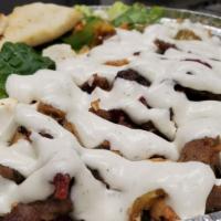 Gyro Platter
 · Hand sliced gyro meat over yellow rice topped with our white garlic sauce. Comes with a side...