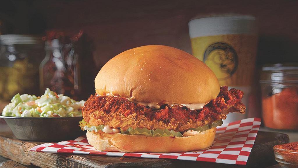 Nashville Hot Sandwich · Our Big Crispy Chicken Breast coated  in our signature Nashville Hot Seasoning, topped with our Lotta Zing® Sauce and 5 pickles  on a freshly baked yeast roll bun.