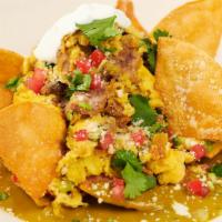 Green Chilaquiles With Carnitas & Eggs · Tender Slow-Cooked Pork with Roasted Poblano Peppers, Cheese, Onions, Cilantro and Crisp Cor...