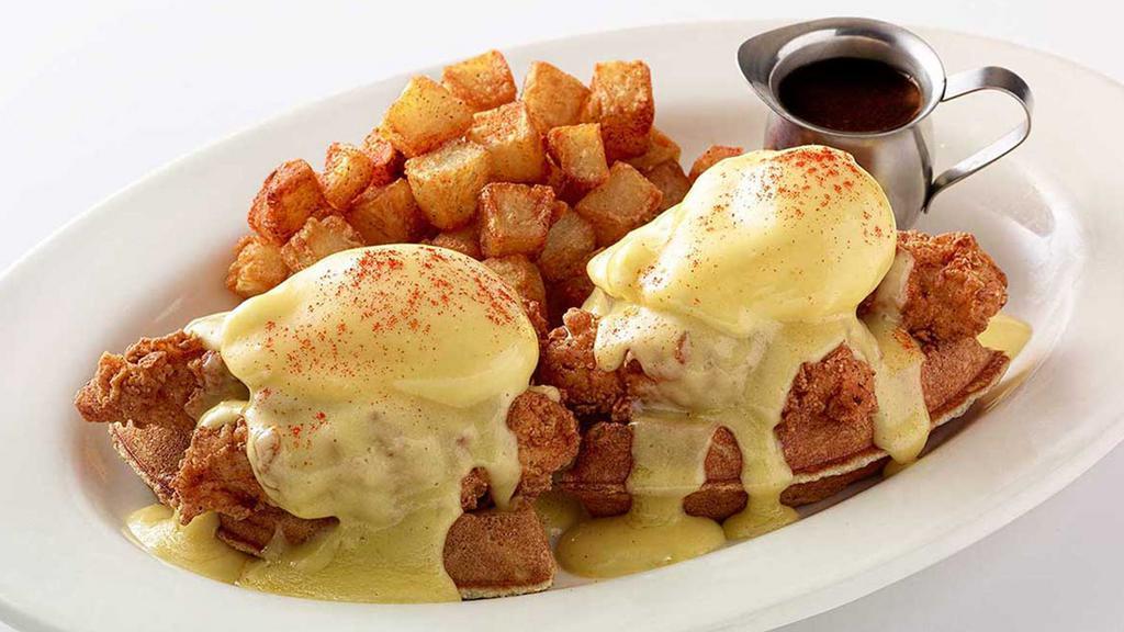 Fried Chicken & Waffles Benedict · Our Belgian Waffle Topped with Crispy Fried Chicken Strips, Poached Eggs and Hollandaise. Served with Maple-Butter Syrup