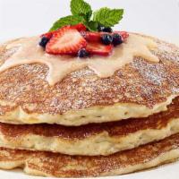 Lemon-Ricotta Pancakes · Our Buttermilk Pancakes with Ricotta Topped with Lemon Glaze, Strawberries and Blueberries