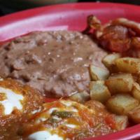 Huevos Rancheros · Two eggs on a corn tortilla topped with salsa ranchera. Served with with breakfast potatoes ...