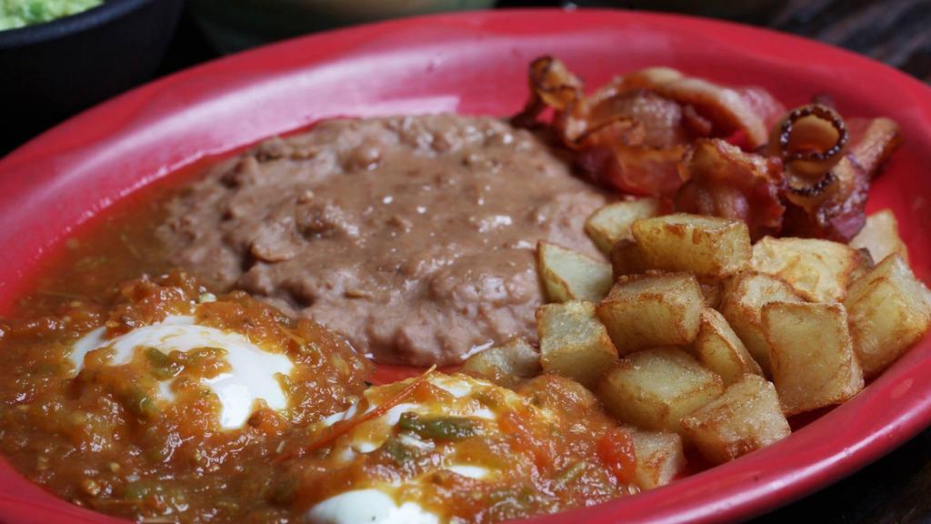 Huevos Rancheros · Eggs over-easy topped with cheese and spicy sauce.