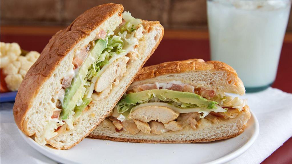 Torta · Your choice of meat, refried beans, lettuce, tomato, sour cream, and avocado.