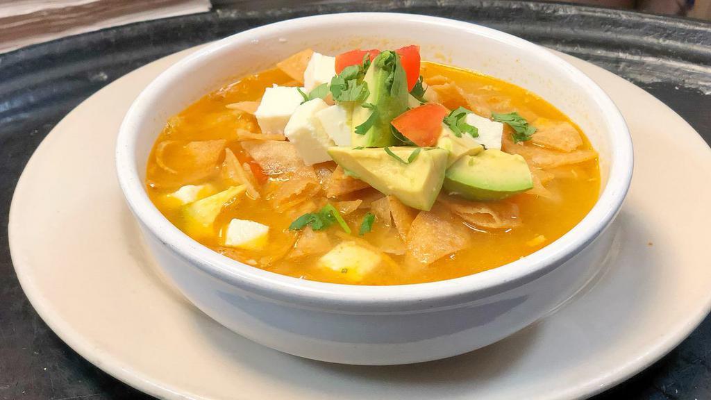 Tortilla Soup · Shredded all white meat, vegetables, crispy tortilla chips. Topped with avocado, crispy tortilla strips, and queso fresco cubes.