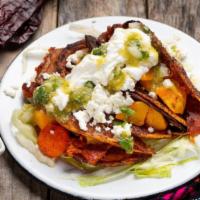 Enchiladas Potosinas · Adobo fried corn tortillas, chorizo, carrot, diced potatoes, topped with lettuce, tomato, cr...