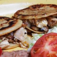 Gorditas · Two masa pattie sandwiches topped with your choice of meat and melted cheese, with charro be...