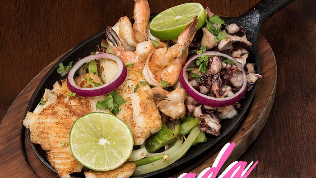 Mariscada Parrillada · Grilled octopus, shrimp, and tilapia served with Spanish rice, charro beans, pico de gallo, guacamole, lettuce, tomato, sour cream, Monterey jack cheese, and your choice of tortilla.