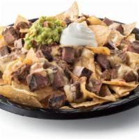 Steak Fajita Nachos · Diced steak fajitas and crispy tortilla chips served with refried beans & queso with a side ...