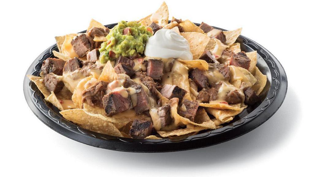 Steak Fajita Nachos · Diced steak fajitas and crispy tortilla chips served with refried beans & queso with a side of sour cream & guacamole