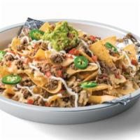 Kickin' Grande Nachos · Tortilla chips topped with refried beans, your choice of protein (ground Beef, diced Steak F...