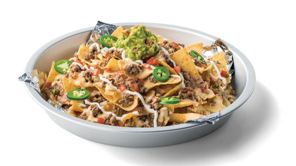 Kickin' Grande Nachos · Tortilla chips topped with refried beans, your choice of protein (ground Beef, diced Steak Fajita or diced Chicken Fajita), queso, guacamole, pico de gallo, slice of fresh jalapenos & a drizzle of sour cream.