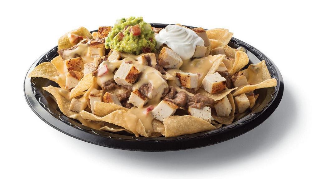 Chicken Fajita Nachos · Diced chicken fajitas and crispy tortilla chips served with refried beans & queso with a side of sour cream & guacamole
