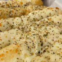 Cheesy Bread · Buuttery garlic bread topped with four cheese blend and oregano. Served with warm marinara.