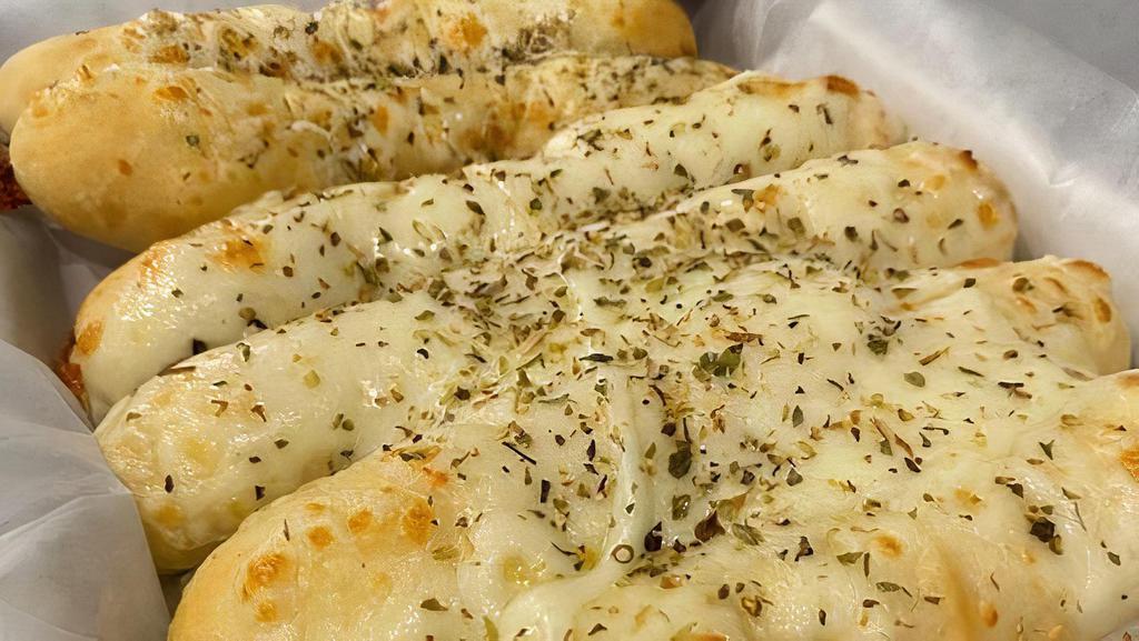 Cheesy Bread · Buuttery garlic bread topped with four cheese blend and oregano. Served with warm marinara.