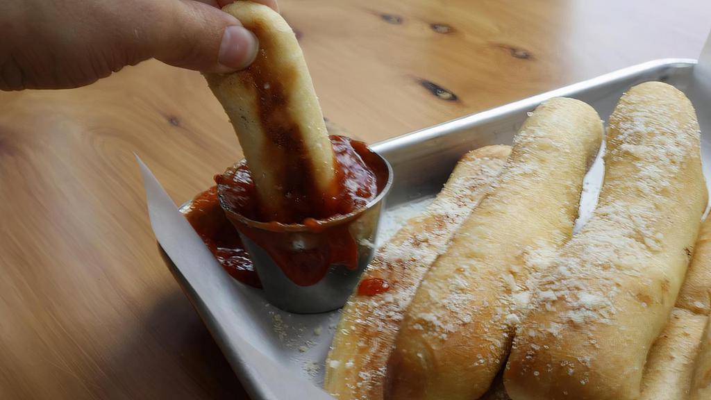 6 Bread Sticks · Buttery garlic bread topped with grated parmesan and served with warm marinara.