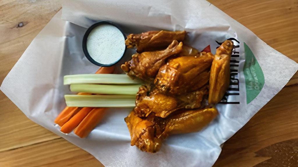 10 Traditional Wings · Bone in wings tossed in your favorite sauce. Served with celery & carrots. Your choice of dressing.