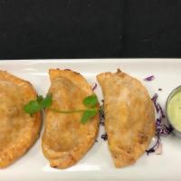 Empanaditas · Three, South American style, white cheese, chicken or ground beef.