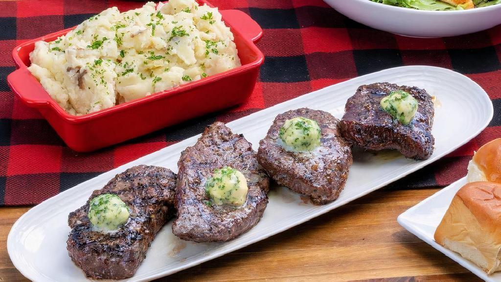 Sirloin Steak ~ Party Pack · four grilled-to-order sirloin steaks · garlic parsley butter · choice of four individual sides · family size House Salad · six dinner rolls with butter · feeds a party of 4
