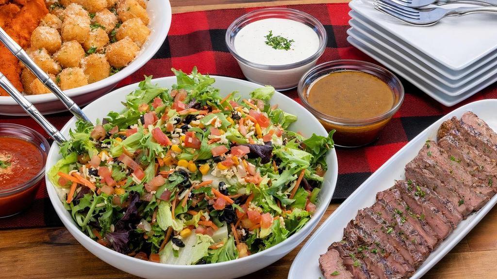 Steak Salad ~ Family Size · grilled sirloin · mixed greens · carrots · tomatoes · pico de gallo · roasted corn · black beans · pepper jack · choice of dressing · feeds a party of 4