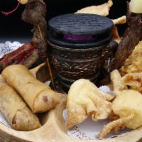 Pu Pu Platter · A sampler of appetizers. Egg rolls, chicken wings, crab puffs, BBQ ribs, fried wontons and b...