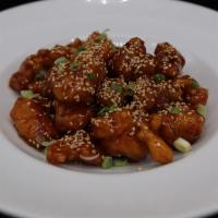 Sesame Chicken · Battered chicken chunks deep fried in a delicious brown sauce and served with sprinkled sesa...