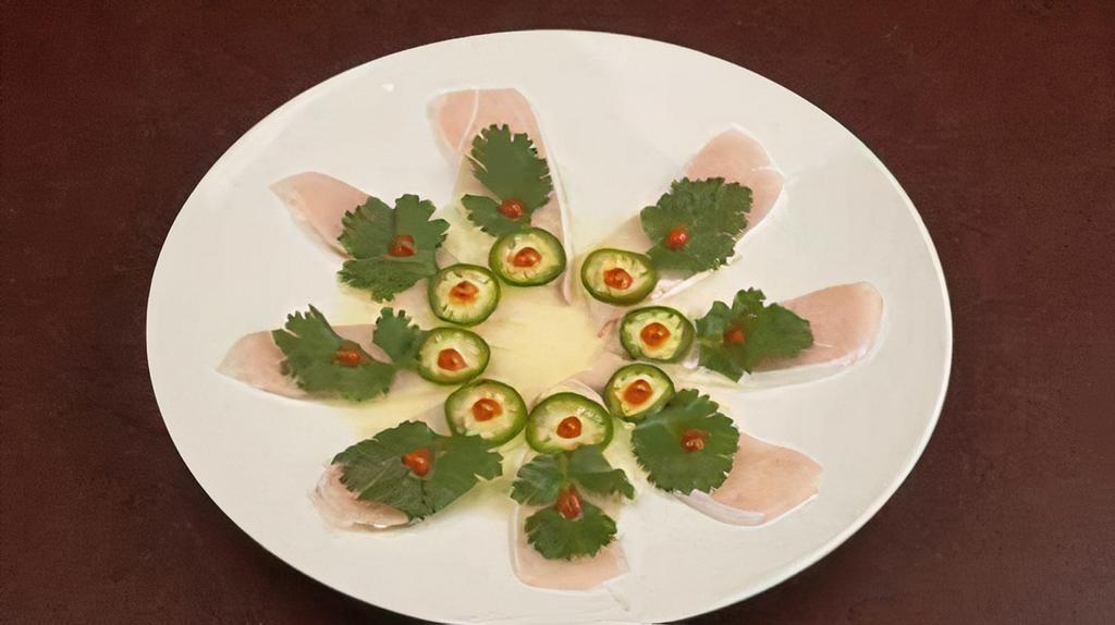 Razor /Ytail · Thinly sliced yellowtail tuna topped with cilantro, serrano chiles, and sriracha sauce finished with yuzu sauce.
