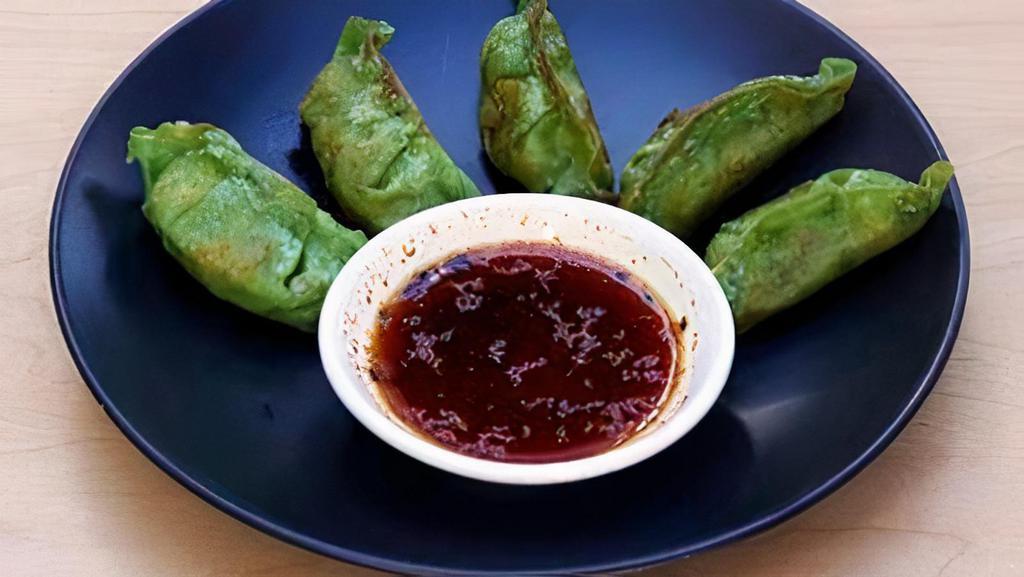Gyoza Vegatable · Pan-seared Japanese pot-sticker dumplings filled with nine different kinds of vegetables wrapped in a spinach wonton. Served with a tangy, soy-based dipping sauce infused with shichimi pepper (5 pieces).