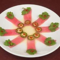 Razor /Tuna · Thinly sliced tuna, topped with cilantro, serrano chilies, sriracha sauce finished with yuzu...