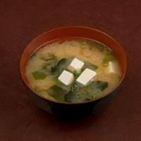 Miso Shiru · The traditional miso soup with tofu cubes, wakame seaweed, and green onions.
